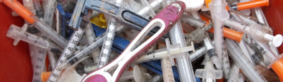 Sharps container full of needles after a needle clean up in Seattle